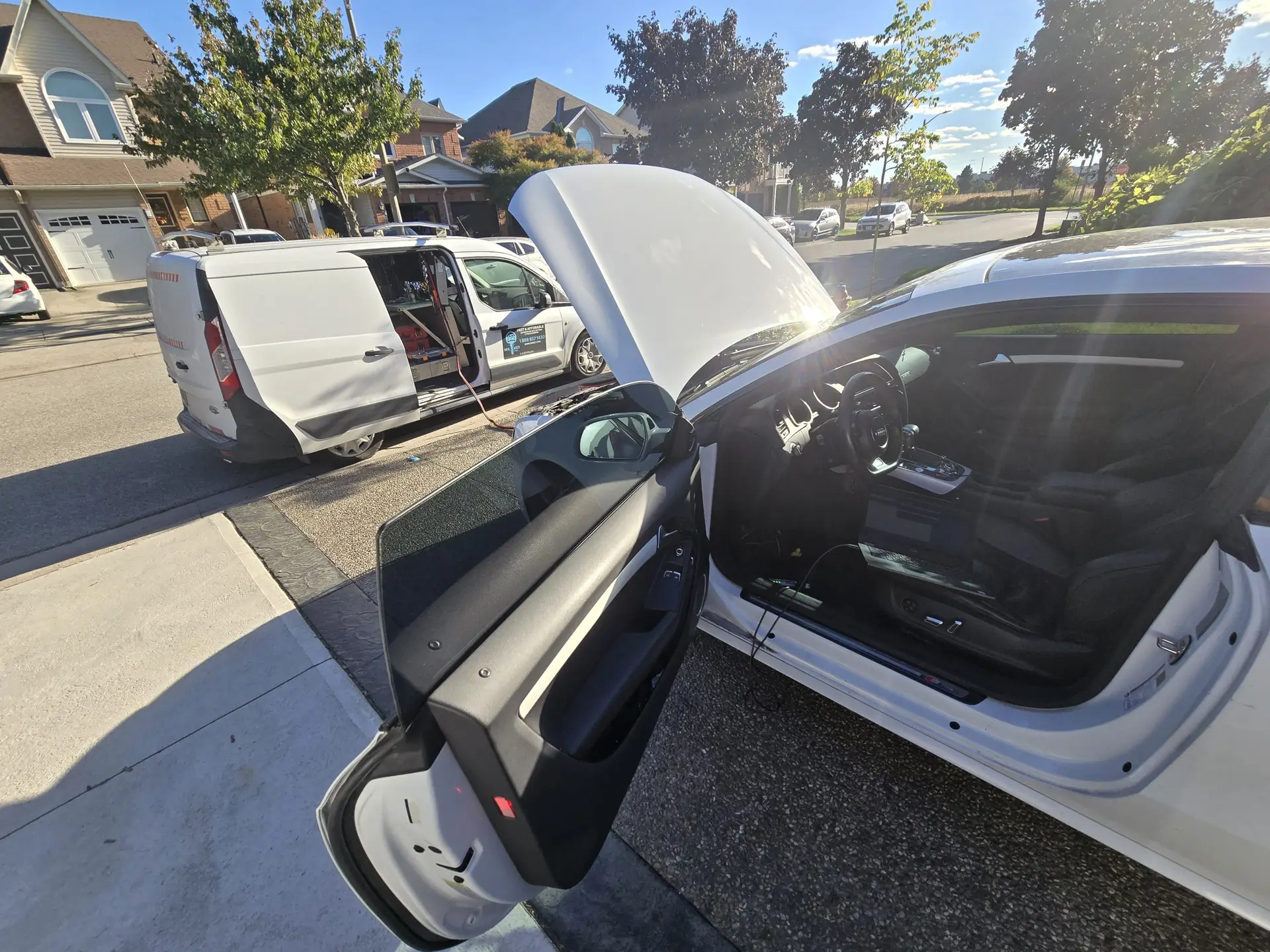 Image of Mr Key Pro work Van, parked at base of driveway with an Audi A5, being coded for a new MMI